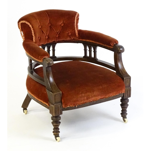 1683 - An early 20thC bow back armchair, with deep buttoned upholstery and raised on turned tapering front ... 