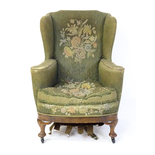 1689 - A 19thC wingback armchair for re-upholstery, the chair raised on walnut cabriole front legs and bloc... 