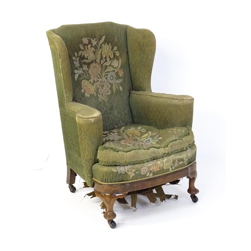 1689 - A 19thC wingback armchair for re-upholstery, the chair raised on walnut cabriole front legs and bloc... 