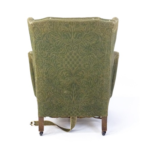 1689 - A 19thC wingback armchair for re-upholstery, the chair raised on walnut cabriole front legs and bloc... 