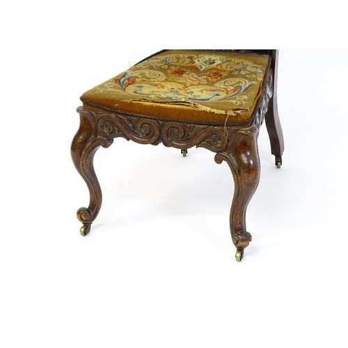 1691 - A mid 19thC rosewood prie-dieu with needlework upholstery, scrolled carved detailing to the seat rai... 