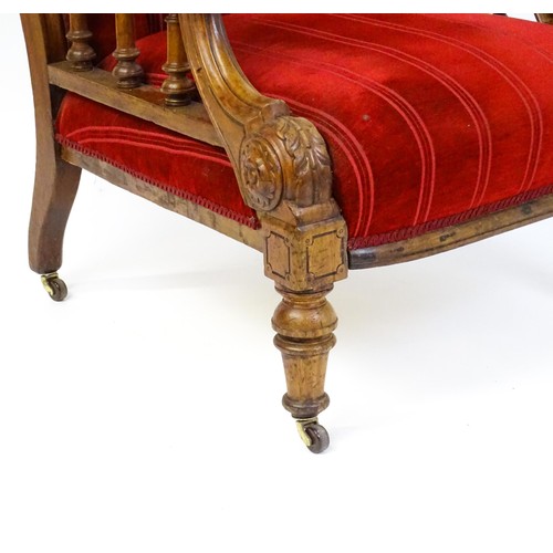 1692 - A late 19thC mahogany armchair, with deep buttoned upholstery and manchettes raised on turned taperi... 