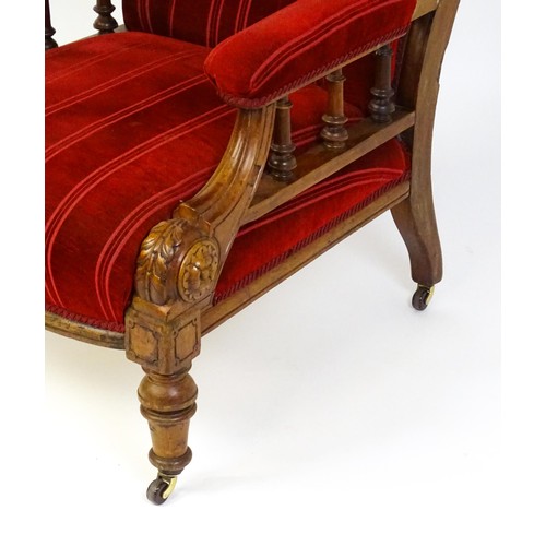 1692 - A late 19thC mahogany armchair, with deep buttoned upholstery and manchettes raised on turned taperi... 