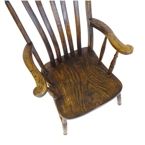 1697 - A late 19thC / early 20thC lathe back Windsor chair, with a bowed top rail, slatted back slats, a sh... 