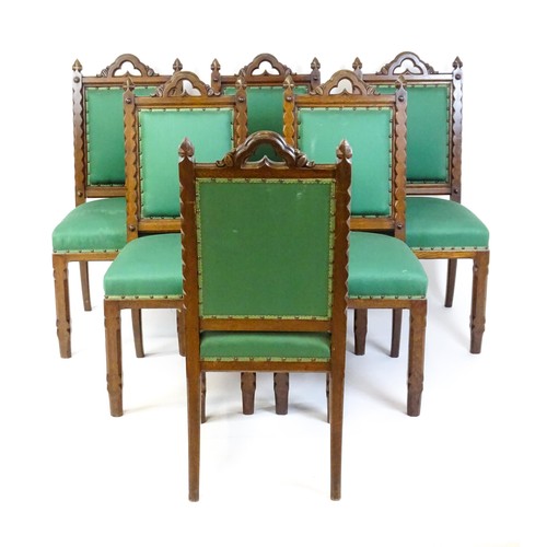 1699 - A set of six 19thC Gothic oak dining chairs , the upright supports having trefoil capitals flanking ... 