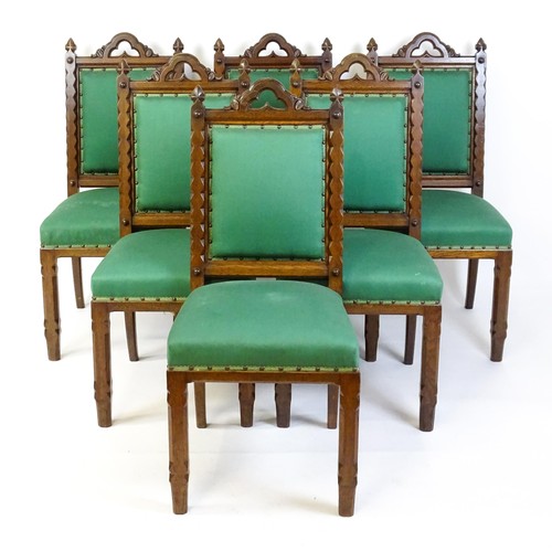 1699 - A set of six 19thC Gothic oak dining chairs , the upright supports having trefoil capitals flanking ... 