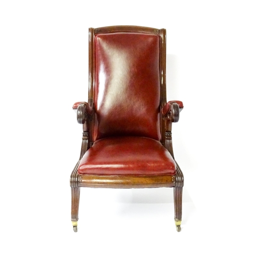 1700 - A Regency period mahogany armchair with a moulded and floral carved frame, having a shaped backrest ... 