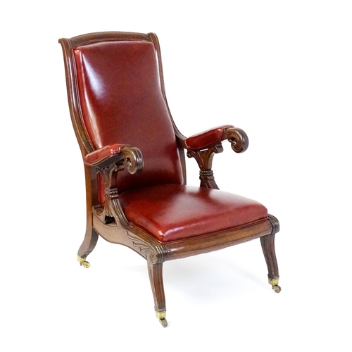 1700 - A Regency period mahogany armchair with a moulded and floral carved frame, having a shaped backrest ... 