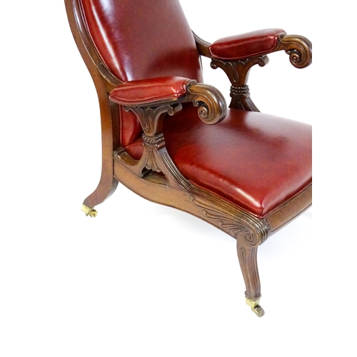 1700 - A Regency period mahogany armchair with a moulded and floral carved frame, having a shaped backrest ... 