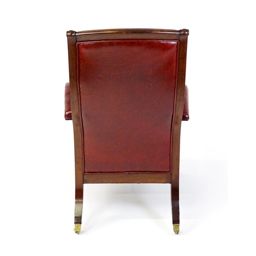 1700 - A Regency period mahogany armchair with a moulded and floral carved frame, having a shaped backrest ... 