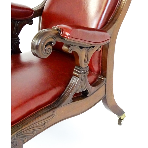 1700 - A Regency period mahogany armchair with a moulded and floral carved frame, having a shaped backrest ... 