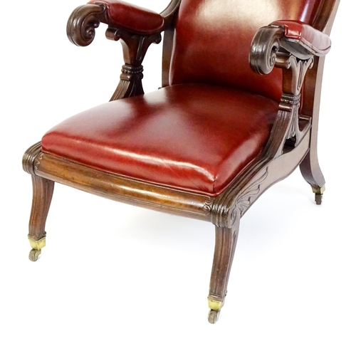 1700 - A Regency period mahogany armchair with a moulded and floral carved frame, having a shaped backrest ... 