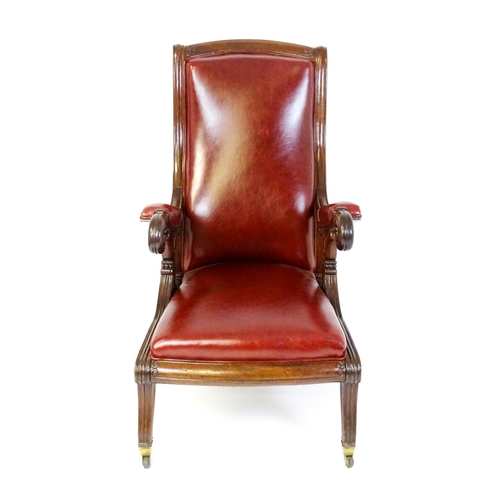 1700 - A Regency period mahogany armchair with a moulded and floral carved frame, having a shaped backrest ... 