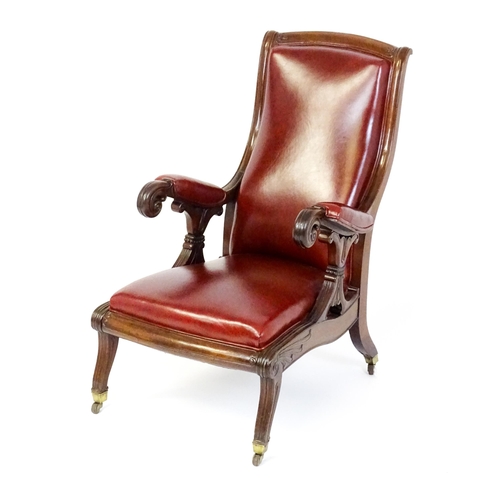 1700 - A Regency period mahogany armchair with a moulded and floral carved frame, having a shaped backrest ... 