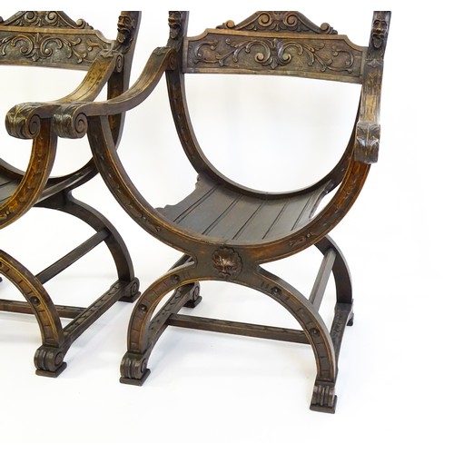 1703 - Two late 19thC / early 20thC Savonarola chairs, the uprights of scrolled form with carved mask detai... 