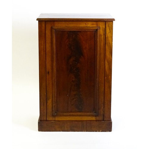 1708 - A late 19thC mahogany cupboard with a rectangular top above a panelled cupboard door containing thre... 