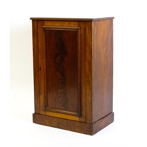 1708 - A late 19thC mahogany cupboard with a rectangular top above a panelled cupboard door containing thre... 