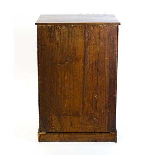 1708 - A late 19thC mahogany cupboard with a rectangular top above a panelled cupboard door containing thre... 