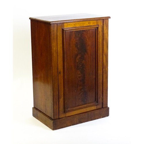 1708 - A late 19thC mahogany cupboard with a rectangular top above a panelled cupboard door containing thre... 