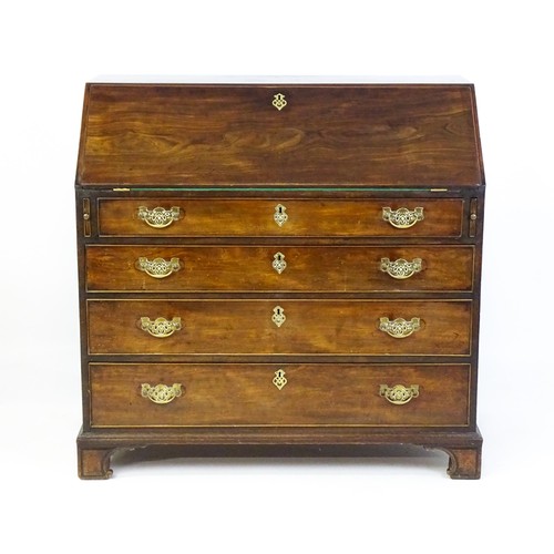 1709 - A mid 18thC mahogany bureau with a fall front above four long graduated drawer, the fall front fitte... 