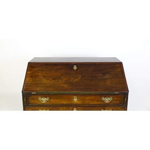 1709 - A mid 18thC mahogany bureau with a fall front above four long graduated drawer, the fall front fitte... 