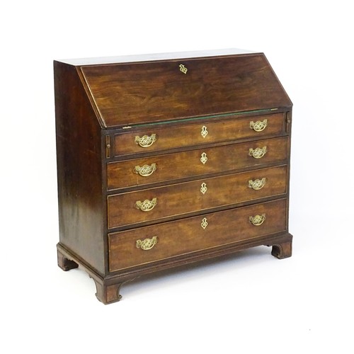 1709 - A mid 18thC mahogany bureau with a fall front above four long graduated drawer, the fall front fitte... 