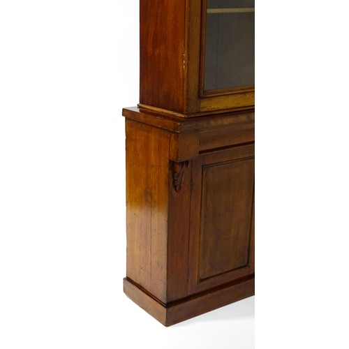 1714 - A Victorian mahogany chiffonier bookcase, the top having a moulded cornice above glazed doors flanke... 