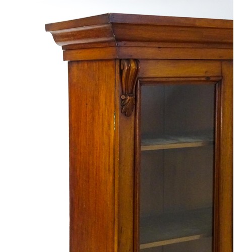 1714 - A Victorian mahogany chiffonier bookcase, the top having a moulded cornice above glazed doors flanke... 