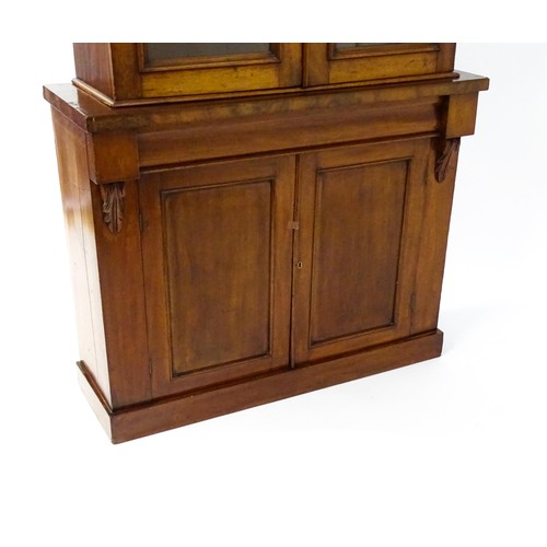 1714 - A Victorian mahogany chiffonier bookcase, the top having a moulded cornice above glazed doors flanke... 