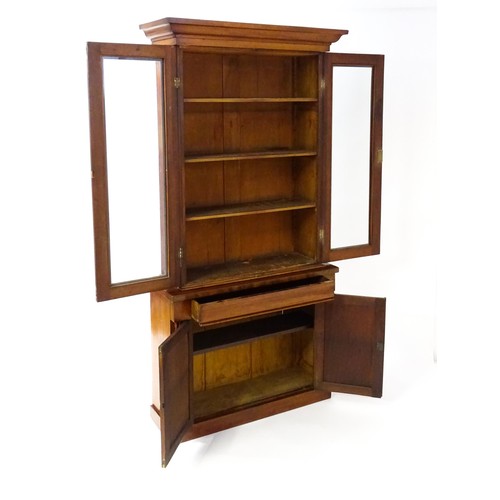 1714 - A Victorian mahogany chiffonier bookcase, the top having a moulded cornice above glazed doors flanke... 