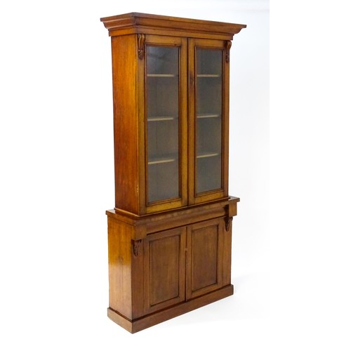 1714 - A Victorian mahogany chiffonier bookcase, the top having a moulded cornice above glazed doors flanke... 