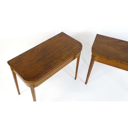 1717 - A pair of Regency mahogany tea tables, both with hinged and rotating crossbanded tops raised on four... 