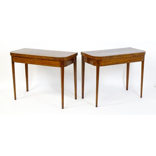 1717 - A pair of Regency mahogany tea tables, both with hinged and rotating crossbanded tops raised on four... 