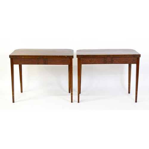 1717 - A pair of Regency mahogany tea tables, both with hinged and rotating crossbanded tops raised on four... 