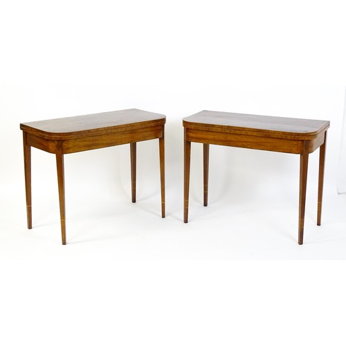 1717 - A pair of Regency mahogany tea tables, both with hinged and rotating crossbanded tops raised on four... 