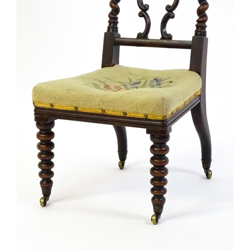 1721 - A Victorian rosewood side chair surmounted by turned finials and having barley twist uprights, the c... 