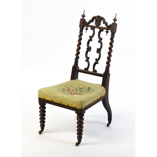 1721 - A Victorian rosewood side chair surmounted by turned finials and having barley twist uprights, the c... 