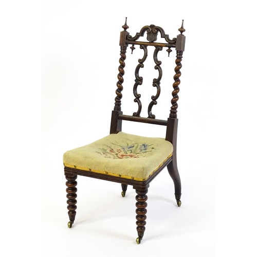 1721 - A Victorian rosewood side chair surmounted by turned finials and having barley twist uprights, the c... 