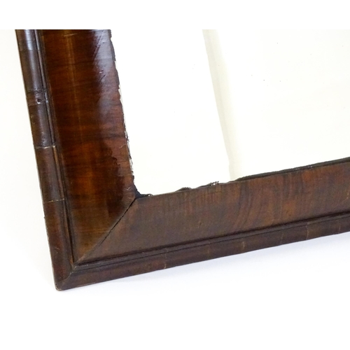 1728 - A late 18thC / early 19thC cushion mirror with a moulded walnut frame. 22