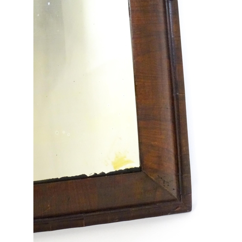 1728 - A late 18thC / early 19thC cushion mirror with a moulded walnut frame. 22