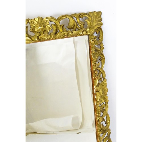 1729 - A 19thC water gilded carved wooden mirror with original wide bevelled glass and profuse carved pierc... 