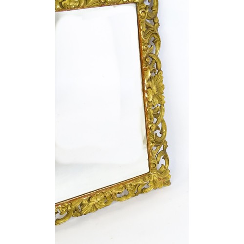 1729 - A 19thC water gilded carved wooden mirror with original wide bevelled glass and profuse carved pierc... 