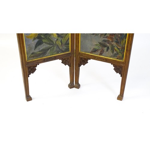 1730 - A late 19thC / early 20thC walnut two fold screen with a floral carved pediment and two canvas panel... 