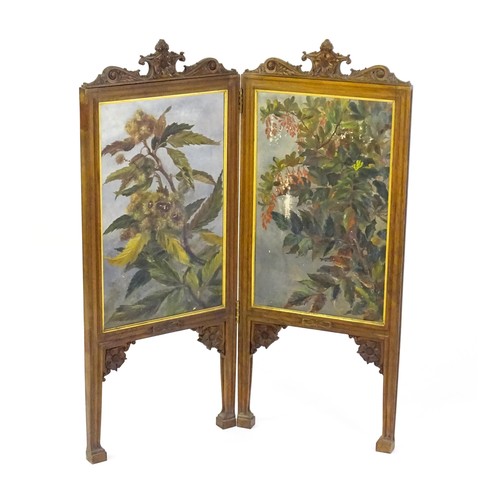 1730 - A late 19thC / early 20thC walnut two fold screen with a floral carved pediment and two canvas panel... 