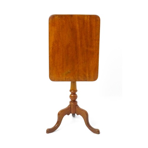 1738 - A late 19thC mahogany tripod table with an oblong top above a turned pedestal and three cabriole leg... 