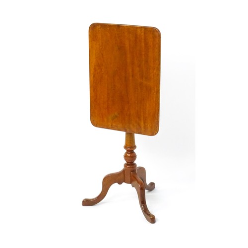 1738 - A late 19thC mahogany tripod table with an oblong top above a turned pedestal and three cabriole leg... 