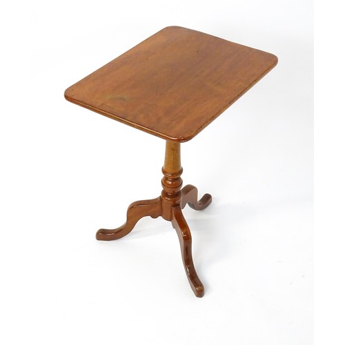 1738 - A late 19thC mahogany tripod table with an oblong top above a turned pedestal and three cabriole leg... 