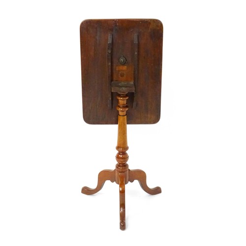 1738 - A late 19thC mahogany tripod table with an oblong top above a turned pedestal and three cabriole leg... 