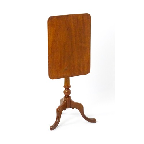 1738 - A late 19thC mahogany tripod table with an oblong top above a turned pedestal and three cabriole leg... 