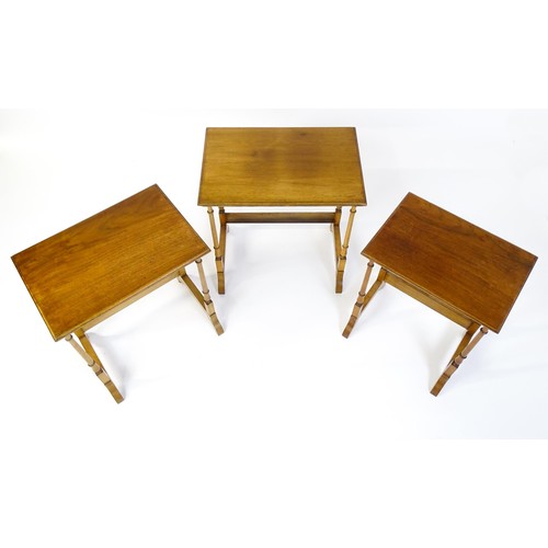 1741 - A nest of three early 20thC walnut tables each with a rectangular top, four turned pillar supports a... 